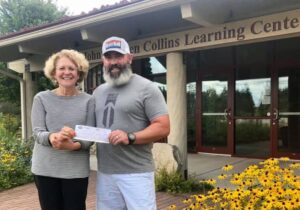 Trent of Bridge Up Brewing craft beer brewery and taprooms in Door County donates a check