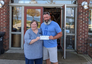 Trent of Bridge Up Brewing craft beer brewery and taprooms in Door County donates a check